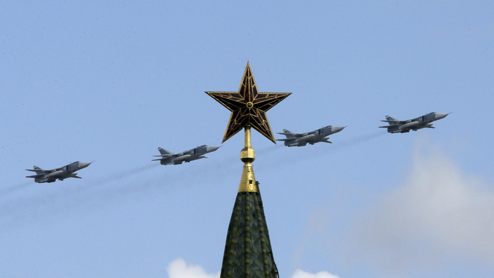 Russian jets fly in formation during rehearsals for the Victory Day military parade, with a tower of the Kremlin seen in the foreground, May 3, 2014.